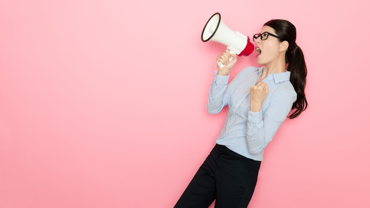 A woman yells into a megaphone. There must be a better way to communicate!