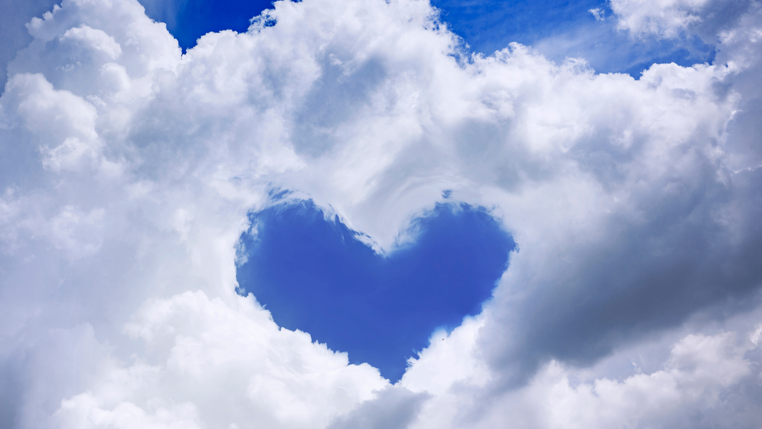 A picture of a blue sky with white clouds, and the clouds are positioned such to create the outline of heart. It's really quite beautiful, I wish you could see it.