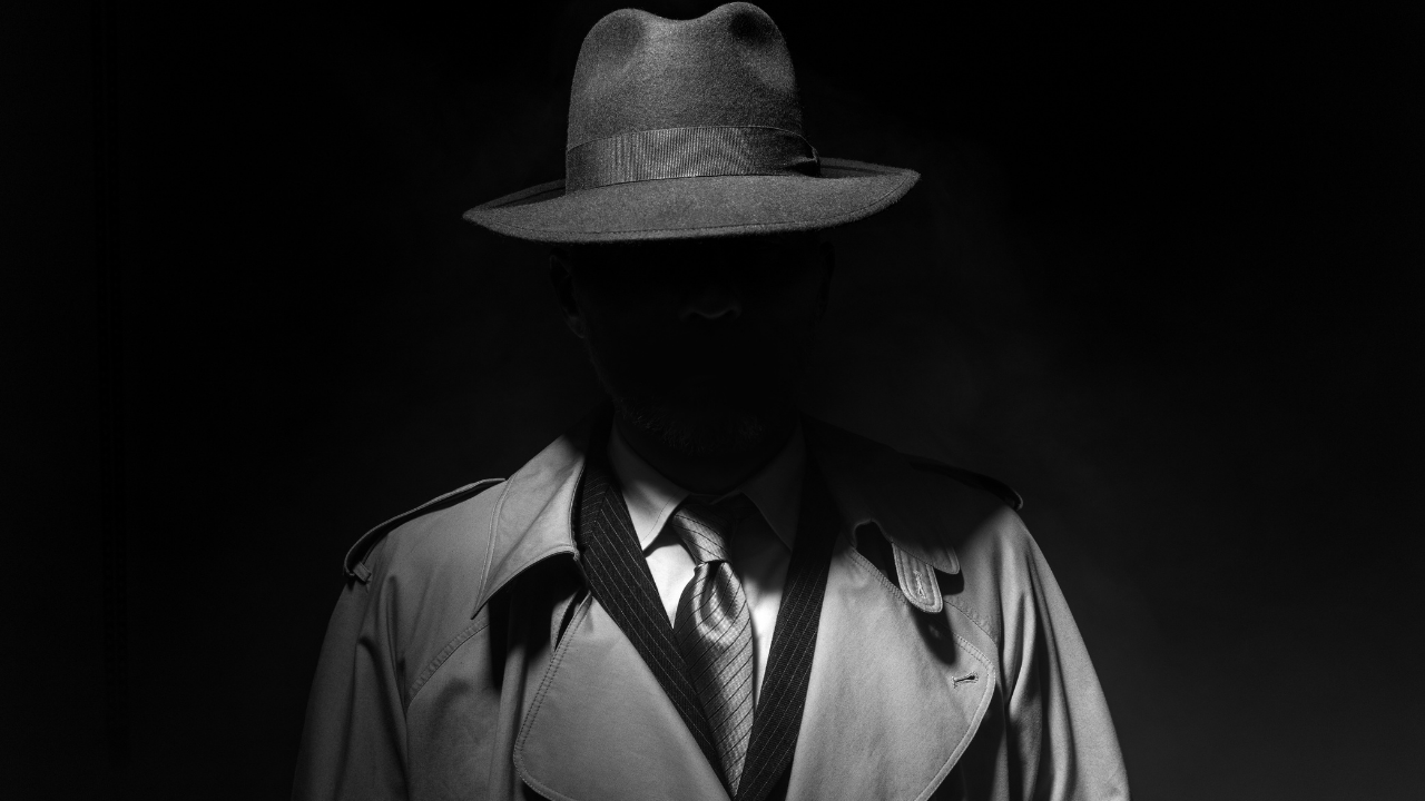 A mobster hides in the shadows