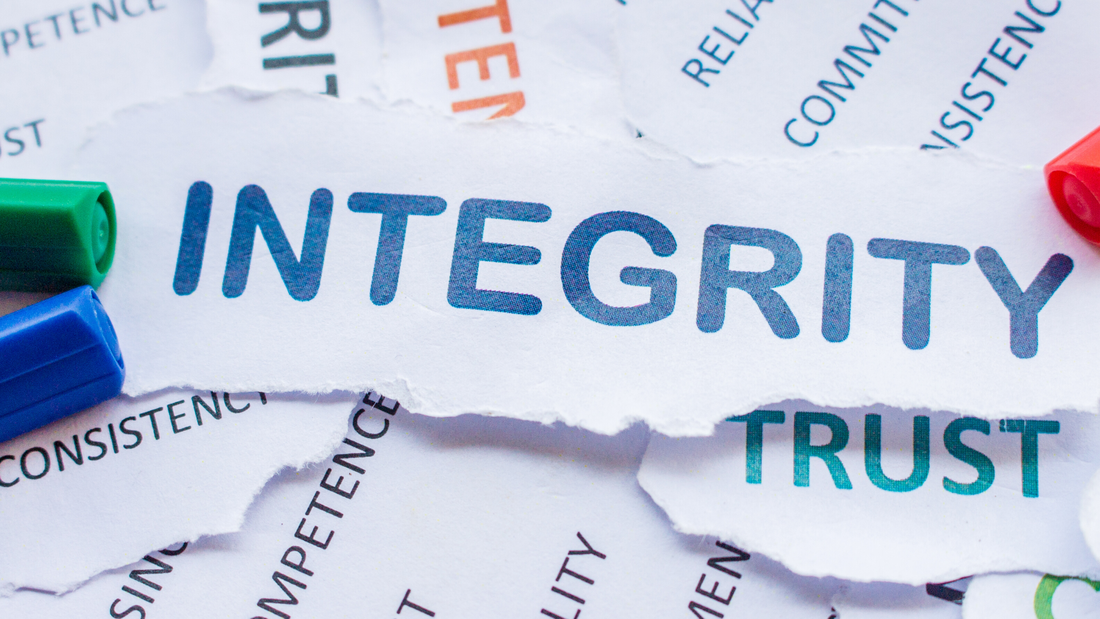 A picture of important words on scraps of paper, and chief among these is INTEGRITY.