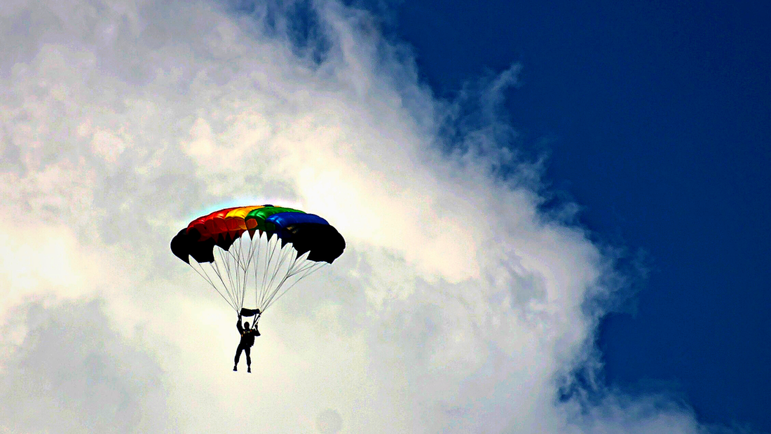 A skydiver gliding through the clouds.