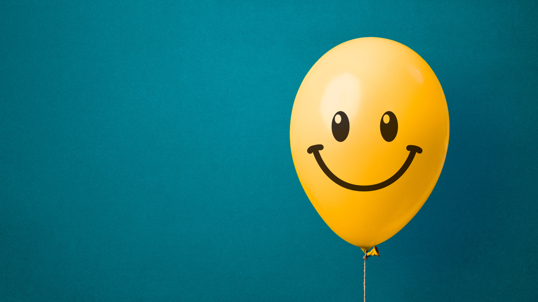 A yellow balloon with a happy face.