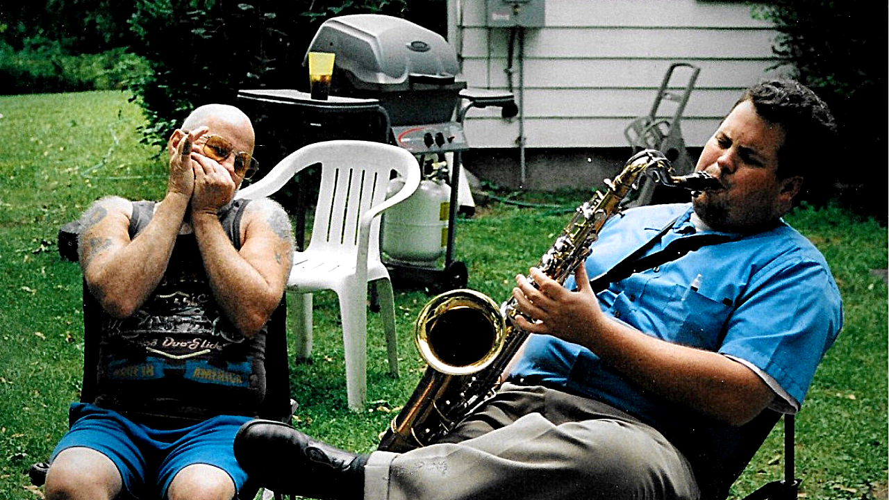 My father plays the harmonica while I play the saxophone.