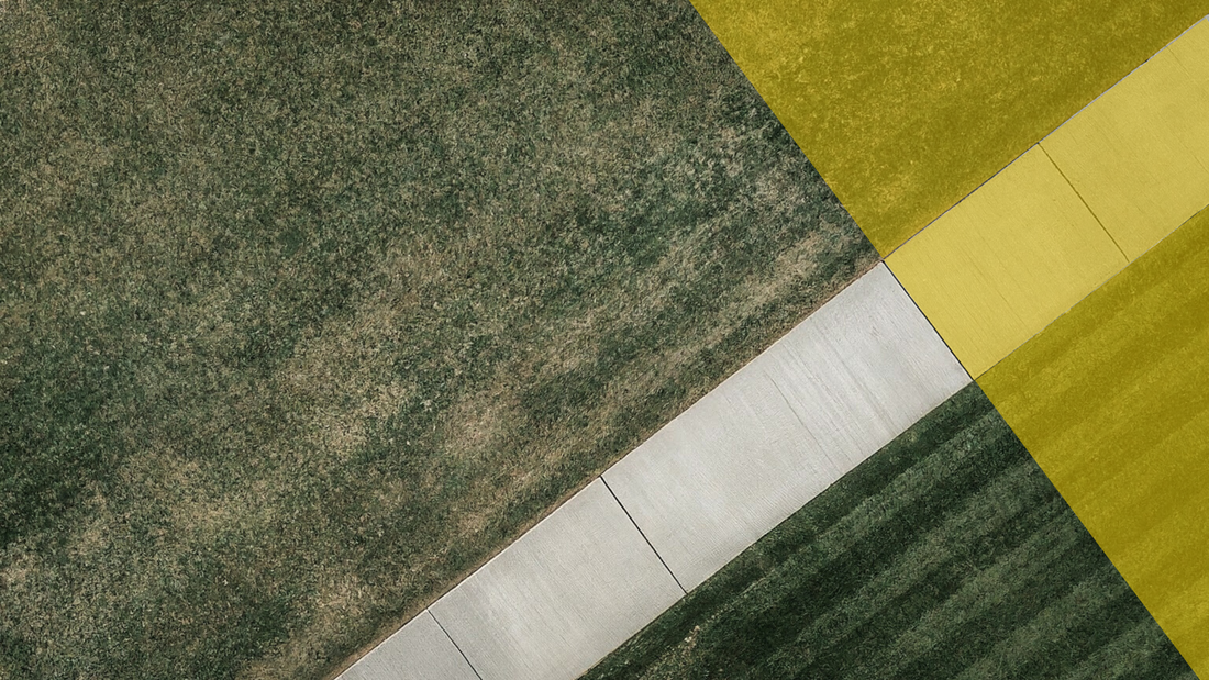 A sidewalk through a field, with a golden boundary.