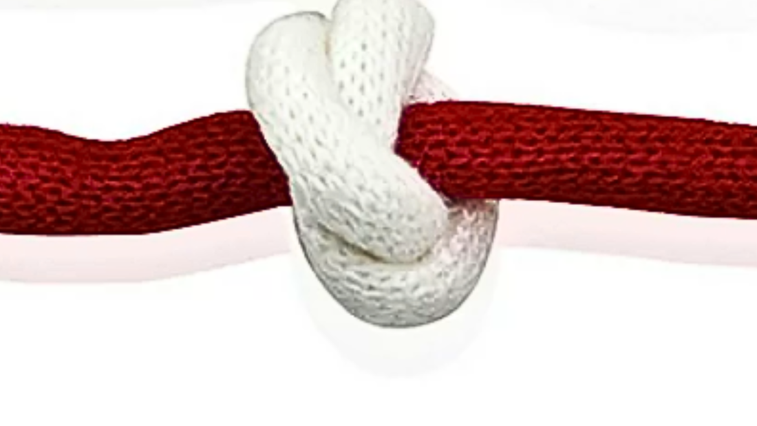 A red rope with a white knot tied in it.