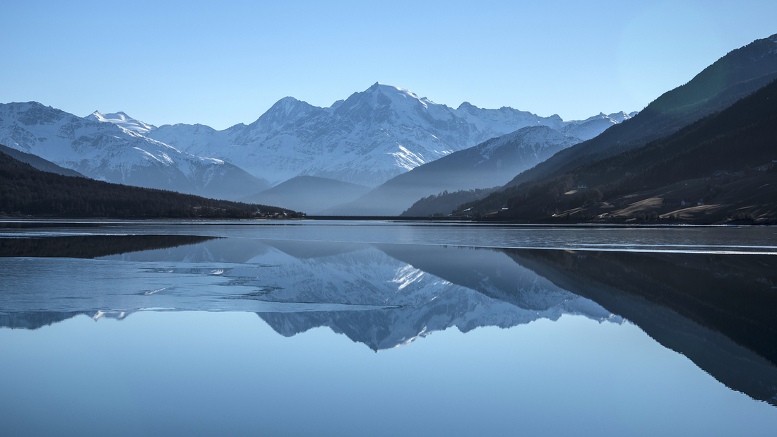 A mountain reflecting onto a lake.