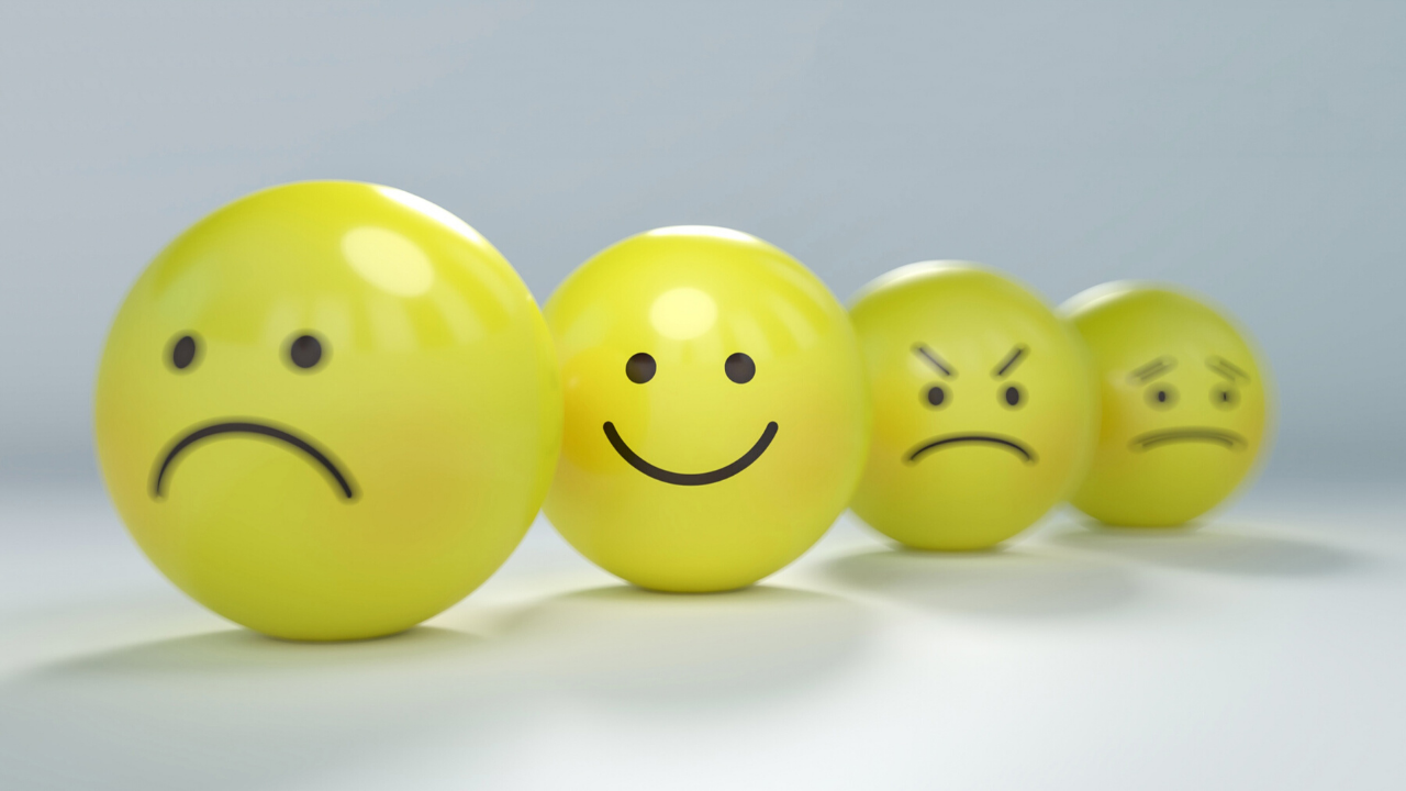 A picture of three yellow balls with sad, upset, and angry face, and one yellow ball with a happy face. Which ball do you choose?